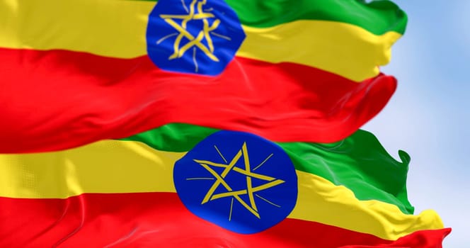 Ethiopia national flags waving in the wind. Horizontal bands of green, yellow, and red with the national emblem centered between them. 3d Illustration render. Selective focus. Rippling fabric