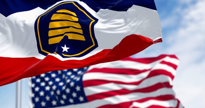 The Beehive Flag of Utah and the american flag waving on a clear day. 3D illustration render. Rippling fabric. Selective focus