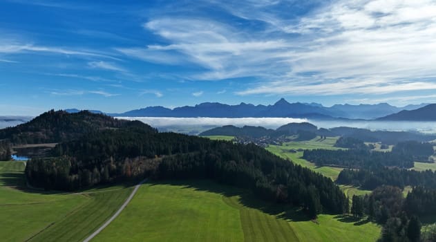Drone shot of the Allgu Alps with fog in front of the mountains