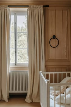 A serene nursery features soft curtains, a crib, and natural light streaming from the window, creating a peaceful atmosphere.