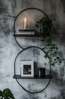 Two circular black shelves display books, a candle, and plants against a textured gray wall, creating a cozy atmosphere.