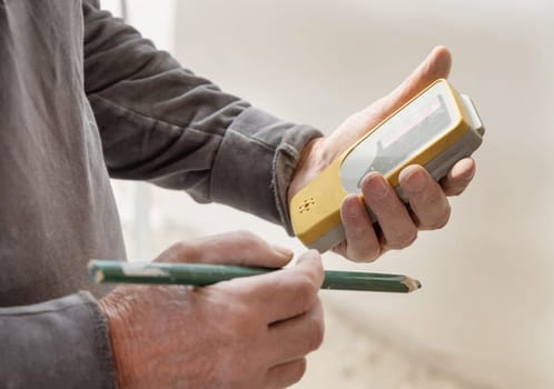 Craftsman hold in dusty hand horizontal rotary laser level device. Engineer during measurement work, construction or renovation site