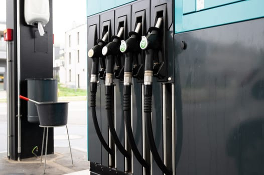 Gasoline dispenser to add gas to car, gas station with petrol and diesel fuel pump nozzles, increase of costs