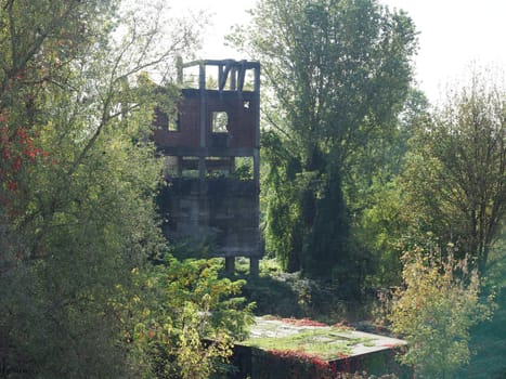 ruins of ancient industrial tower building amidst the wilderness