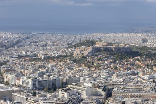 Athens, Greece - October 18, 2022: Aerial view of the city from the Mount Lycabettus on a sunny day. In the distance hill of Acropolis of Athens