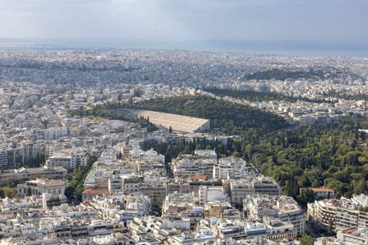 Athens, Greece - October 18, 2022: Aerial view of the city from the Mount Lycabettus on a sunny day. In the distance Panathenaic Stadium