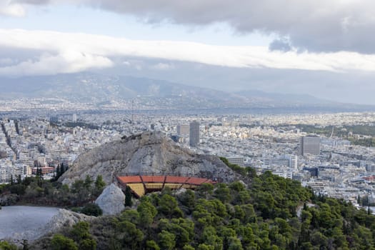 Athens, Greece - October 18, 2022: View from observation deck of Mount Lycabettus of open-air amphitheater, Lycabettus Theatre. Panorama of the city in the distance