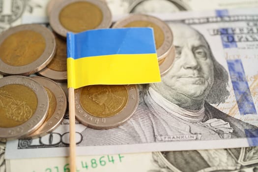 Ukraine flag on coin and banknote money, finance trading investment business currency concept.