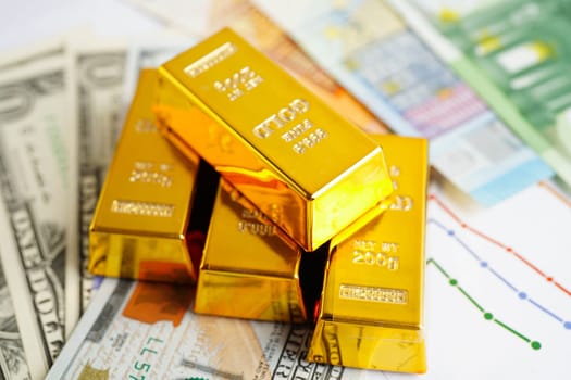 Gold bars with US dollar and Euro banknote money, finance trading investment business currency.