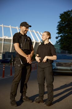 Friendly smiling patrol police officers on the street during the watch