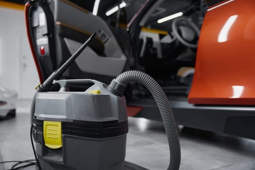 Closeup view on professional vacuum cleaner for car salon washing, cleaning disinfection. Auto wash service concept
