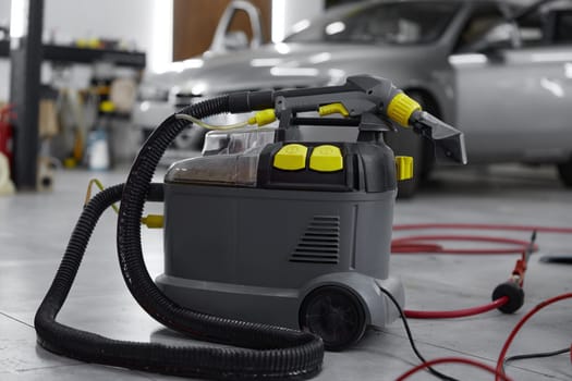 Closeup view on professional vacuum cleaner for car salon washing, cleaning disinfection. Auto wash service concept
