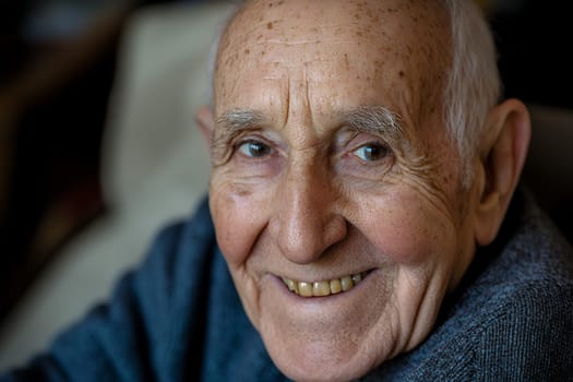 A warm and inviting smile from an elderly man, showcasing wisdom and joy in his expressive eyes.