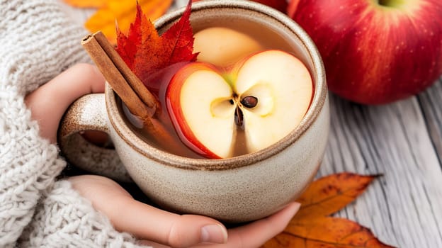 A soothing apple cider garnished with a cinnamon stick and red leaf, perfect for autumn.