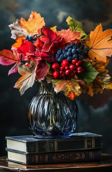 A beautiful arrangement of colorful autumn leaves and berries in a glass vase on top of vintage books in soft lighting.