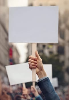 People hands holding banners during a protest parade on city streets. Protesters demonstration with blank pancart for copy space publicity. Multiple activists demand their rights