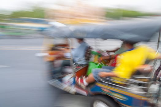 Traditional tuk-tuk from Bangkok, Thailand, in motion blur
