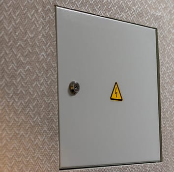 Close up shot of the door to the electric switchboard in the wall of the apartment