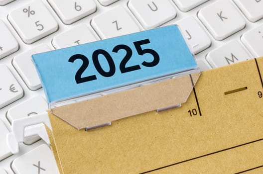 A brown file folder labeled with 2025