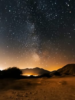 A stunning starry night sky illuminates the desert landscape, showcasing the vastness of the universe.