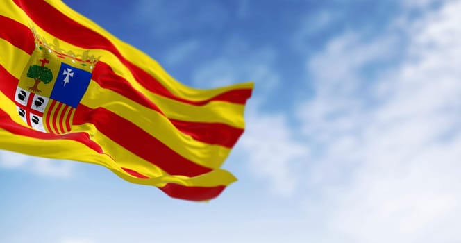 Flag of Aragon waving in the wind on a clear day. Spanish region. 3d illustration render. Selective focus