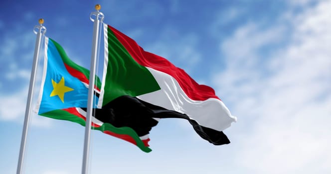 Sudan and South Sudan national flags waving in the wind on a clear day. 3d illustration render. Selective focus