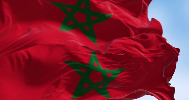 Close-up of Morocco national flag waving in the wind. Red flag with a green pentagram in the center. 3d illustration render. Selective focus. Close-up. Waving flag