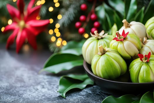 A collection of green pumpkins arranged on a dark bowl with vibrant holiday decorations and foliage in the background.