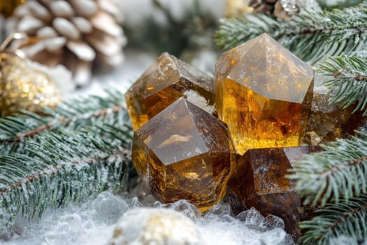 Glimmering amber crystals are arranged on frosted pine branches creating a festive winter display with natural elements.