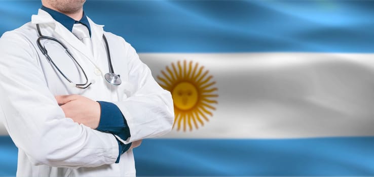 Argentina Health and Care concept. Professional doctor on Argentine flag. Doctor with crossed arms on Argentian flag