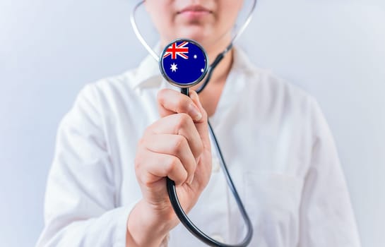 Australia National Healthcare concept. Female doctor showing stethoscope with Australia flag