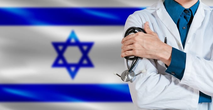 Doctor with stethoscope on Israel flag. Male Doctor holding stethoscope on Israeli flag