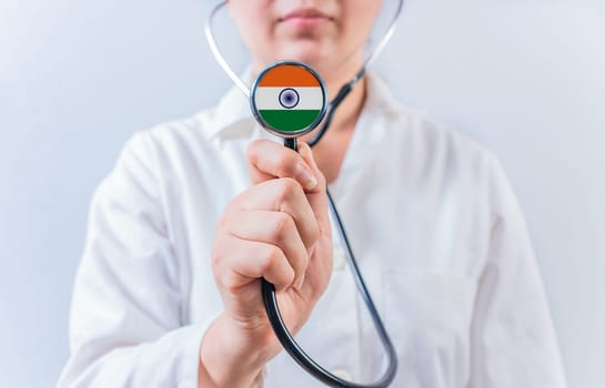 Doctor holding stethoscope with India flag. National Health System of India