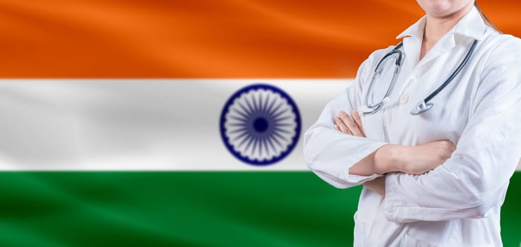 Doctor with crossed arms on India flag. India Health and Care concept. Female doctor on India flag
