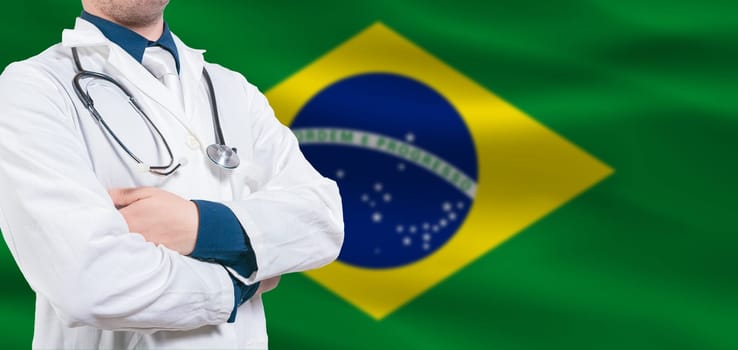 Brazilian Health and Care concept. Professional doctor on Brazilian flag. Doctor with crossed arms on Brazilian flag