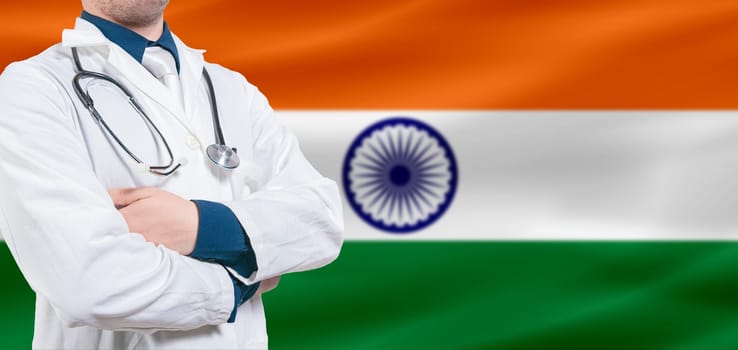 India Health and Care concept. Professional doctor on India flag. Doctor with crossed arms on India flag