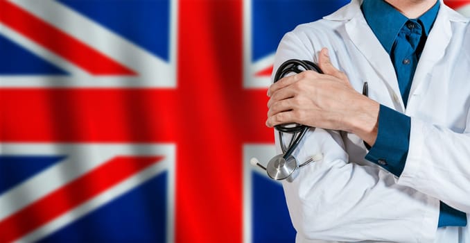 Doctor with stethoscope on UK flag. Male Doctor holding stethoscope on British flag