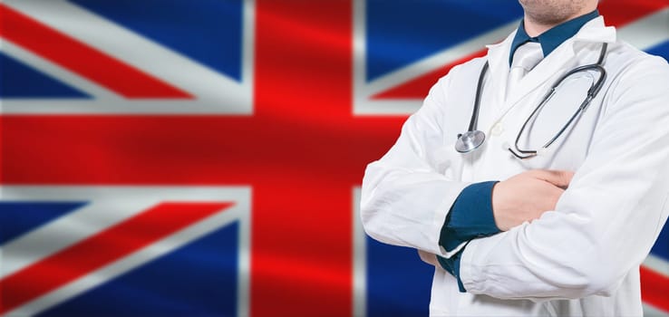 UK Health and Care concept. Professional doctor on British flag. Doctor with crossed arms on British flag.
