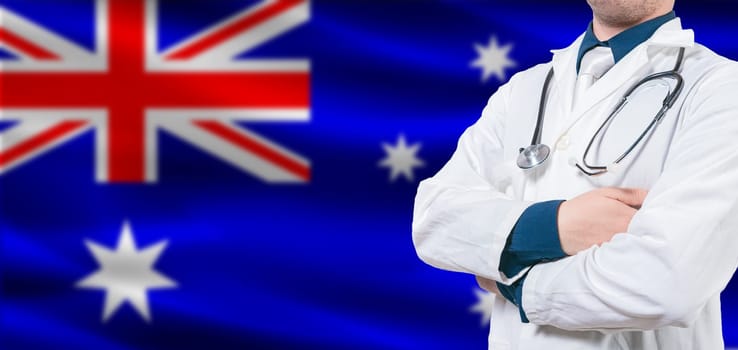 Australian Health and Care concept. Professional doctor on Australia flag. Doctor with crossed arms on Australian flag