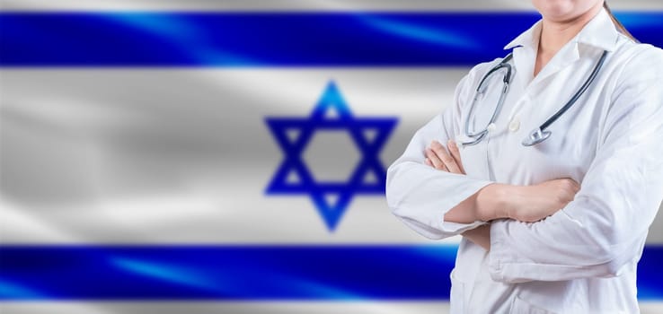 Doctor with crossed arms on Israel flag. Israeli Health and Care concept. Female doctor on Israel flag