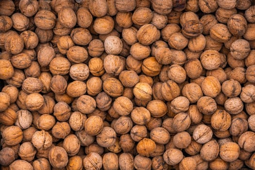 pile of unpeeled walnuts with high angle view, full-frame texture and background