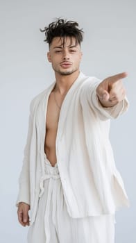 A confident man in a white outfit points forward, conveying a sense of direction and purpose.