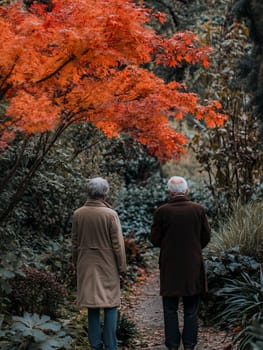 An elderly couple walks together in a park filled with vibrant autumn leaves, enjoying a peaceful stroll.