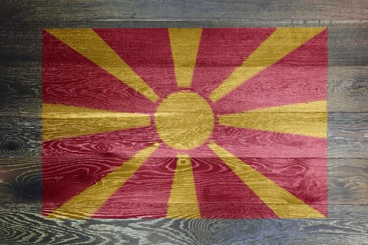 A North Macedonia flag on rustic old wood surface background