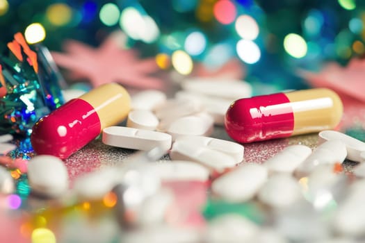 Colorful capsules and white tablets lay scattered on a shiny surface decorated for a celebration or party showcasing vibrant colors.