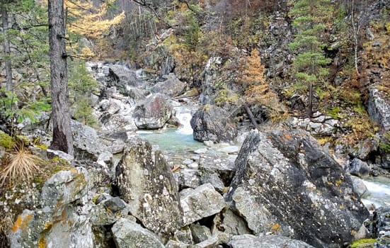 Mountain river. Stones and water of a mountain river. The mountains are said.