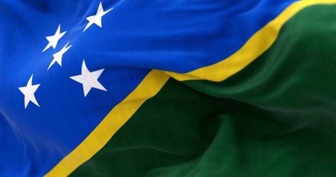 National flag of Solomon Islands waving in the wind on a clear day. Solomon Islands is a sovereign country in Oceania. 3d illustration render.