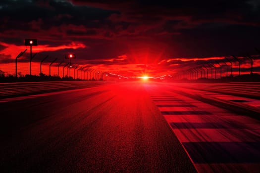 Empty racing circuit track illuminated by dramatic red sunset