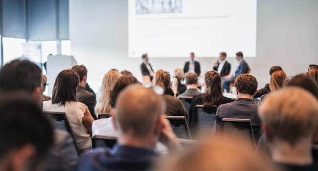 Interview and round table discussion at business convention and presentation. Audience at the conference hall. Business and entrepreneurship symposium.