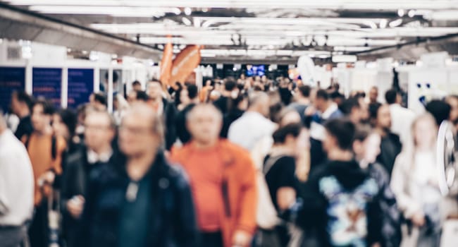 Abstract blurred people at exhibition hall of expo event trade show. Business convention show or job fair. Business concept background